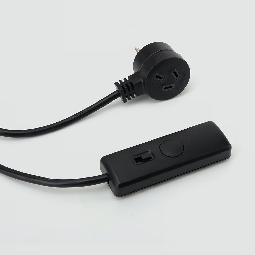 A black hand dimmer and switch with a piggyback plug and a green indicator light.